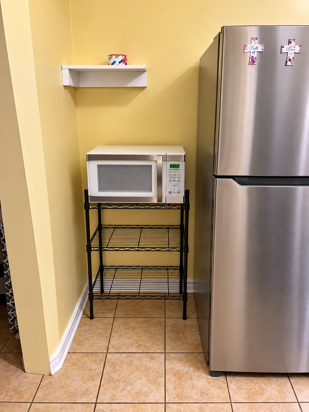 Well-equipped kitchen — microwave, refrigerator, and ample counter space